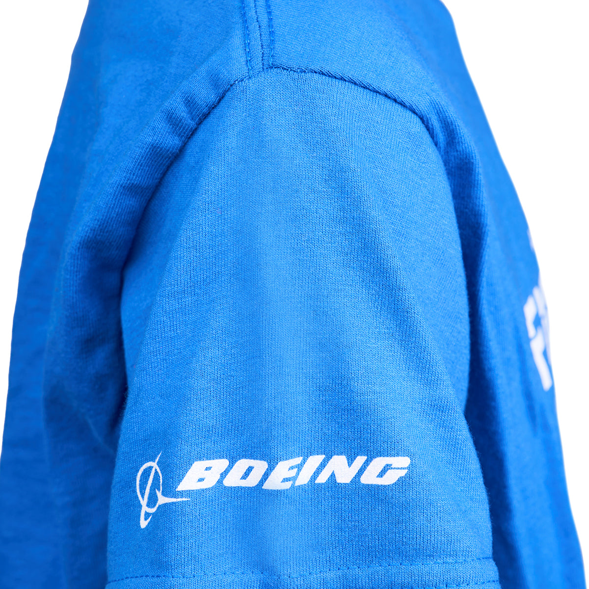 Close-up of the sleeve on the Boeing Fighters F/A-18 Youth T-Shirt, showcasing the white Boeing logo near the hem—a great choice for young aviation fans.