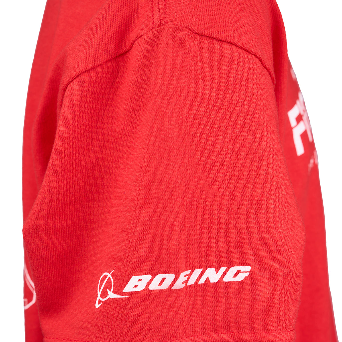 A close-up of the sleeve of the Boeing Fighters Youth T-Shirt shows the white Boeing logo and text near the hem, inspired by Air Dominance Fighters.