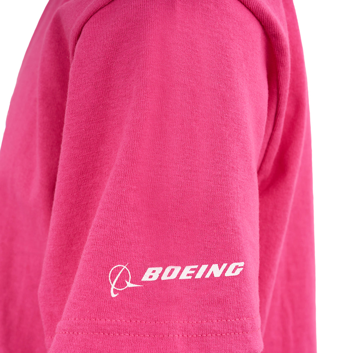 A close-up of the Boeing Rosie Kids T-Shirt by BOEING, featuring a pink cotton jersey short sleeve with a white Boeing logo and stylized emblem.