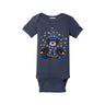 Introducing the Boeing 2026 Jet Snowflake Onesie by BOEING—a navy blue baby bodysuit adorned with a charming teddy bear wearing a winter hat and scarf, surrounded by an adorable snowflake design.