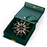 Jet Snowflake sitting inside the dark green gift box.  Dark green velvet box.