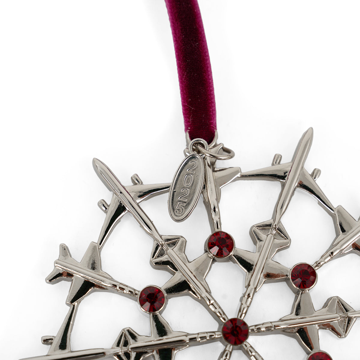 The BOEING 2025 Jet Snowflake Ornament features silver airplane shapes with red gem accents on a dark red velvet ribbon, plus a 2025 tag—an ideal holiday gift for aviation lovers.