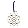 A silver snowflake ornament adorned with dark blue gems hangs from a rich blue velvet ribbon. A small metal tag is attached near the top of the ribbon, making this Boeing Commercial 2026 Jet Snowflake Ornament a unique keepsake for aviation enthusiasts—a perfect tribute to iconic aircraft like the Boeing 777X or Boeing 737 MAX.