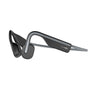 The sleek black Aftershokz Open Move by Boeing are open-ear headphones with bone conduction technology and a lightweight design. The gently curving headband leads to flat rectangular earpieces near the ears, providing ambient sound awareness using PremiumPitch 2.0 technology.