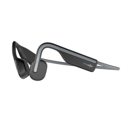 The sleek black Aftershokz Open Move by Boeing are open-ear headphones with bone conduction technology and a lightweight design. The gently curving headband leads to flat rectangular earpieces near the ears, providing ambient sound awareness using PremiumPitch 2.0 technology.
