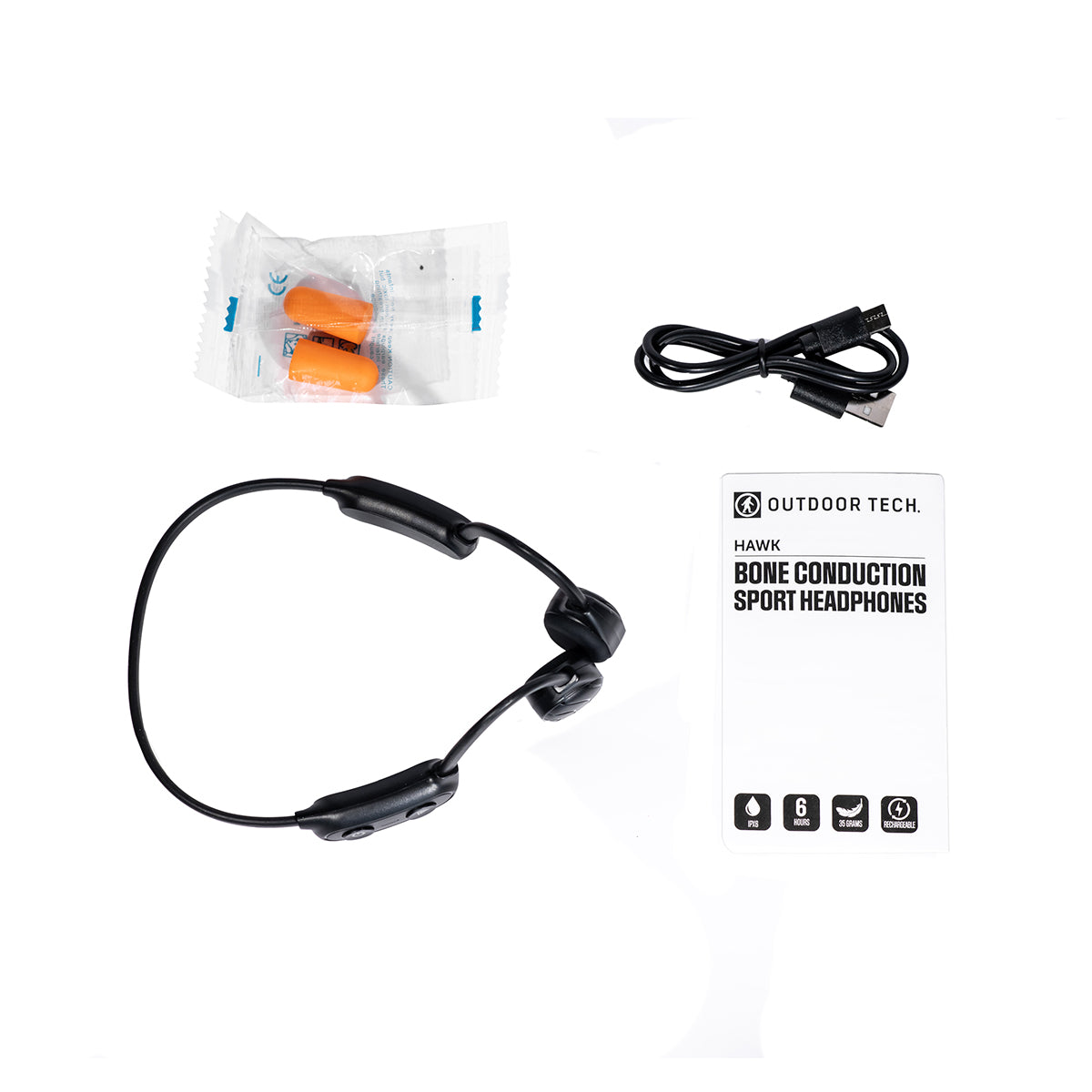 The BOEING Outdoor Tech Boeing Hawk Bone Conduction Headphones, equipped with attached controls and IPX6 waterproof technology, are shown on a white background alongside a pair of orange foam earplugs in plastic packaging, a black charging cable, and an instruction manual.