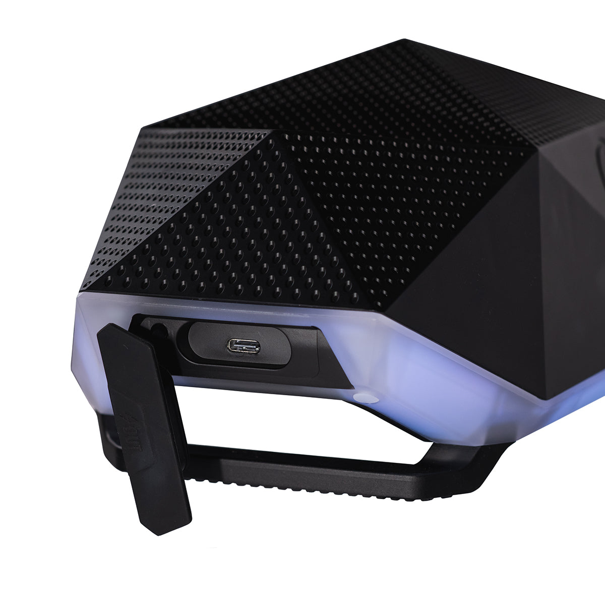 A close-up of the BOEING Outdoor Tech Boeing Rugged Range Speaker, a black, geometric Bluetooth speaker with 360° sound, a visible micro-USB port under a rubber cover, and attached to a black handle or bracket.