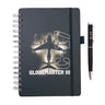 A Boeing C-17 Globemaster Graphic Notebook Pen Set featuring a spiral-bound notebook with a C-17 Globemaster III cargo airplane graphic and a matching black pen labeled C-17.