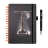 Boeing SLS Artemis II Graphic Notebook Pen Set featuring a spiral-bound notebook with a Space Launch System Artemis II rocket graphic and a matching black pen labeled SLS.