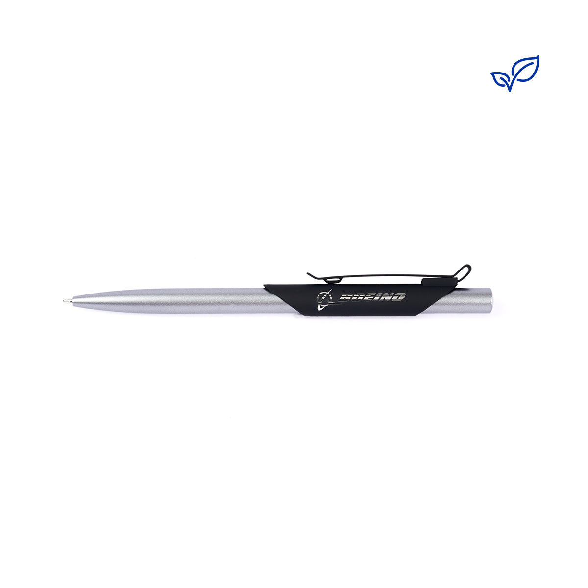 The Boeing Recycled Aluminum Pen, with a sleek silver body and black clip, rests horizontally. Its minimalist design contrasts against a plain white background, while a small blue leaf logo in the top right corner emphasizes its eco-friendly essence.