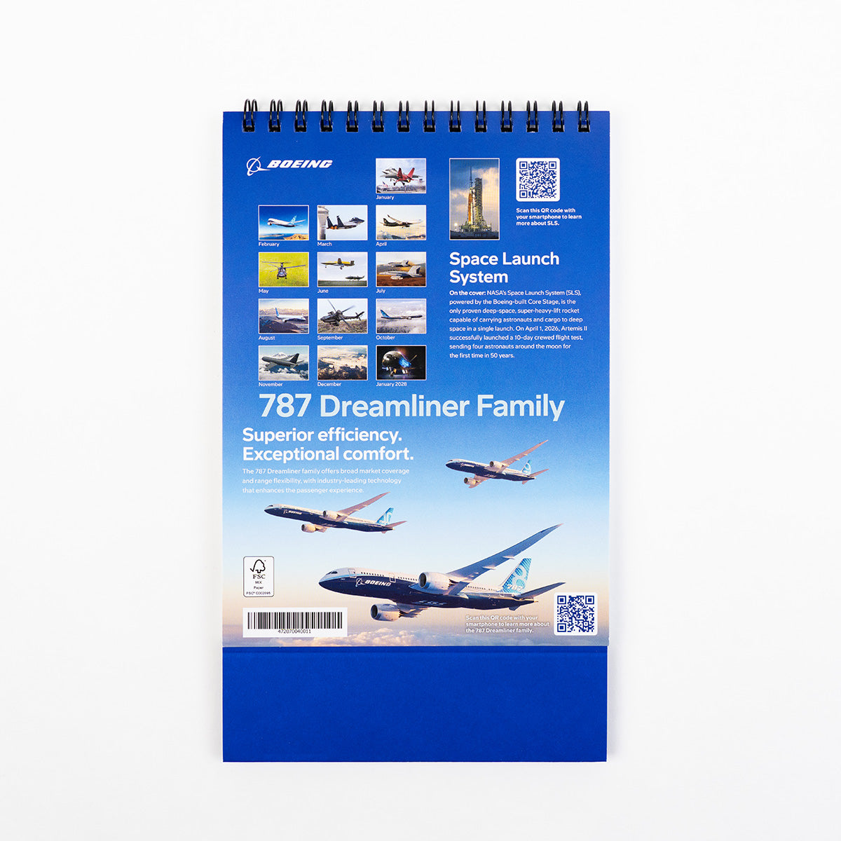 The BOEING 2027 Desktop Calendar showcases stunning aerospace products, featuring images of various aircraft and a description of the 787 Dreamliner Family, along with highlights of the Space Launch System. With a predominantly blue cover displaying multiple airplane photos, this desktop calendar is a must-have for aviation enthusiasts.