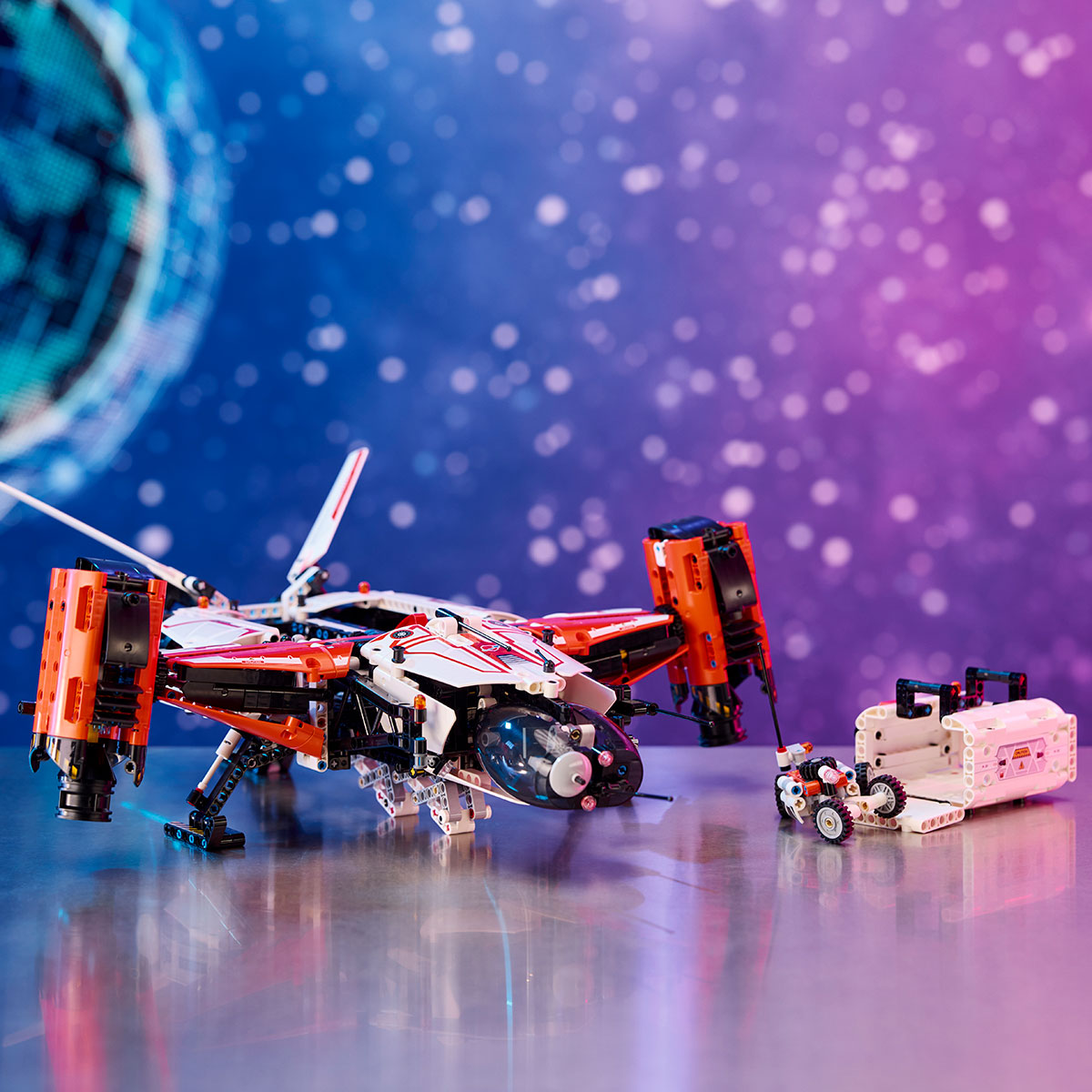 The LEGO® VTOL Heavy Cargo Spaceship LT81 by LEGO in red and white stands on a metallic surface with a mini space rover and cart, set against a blue and purple bokeh background that captures the vastness of outer space.