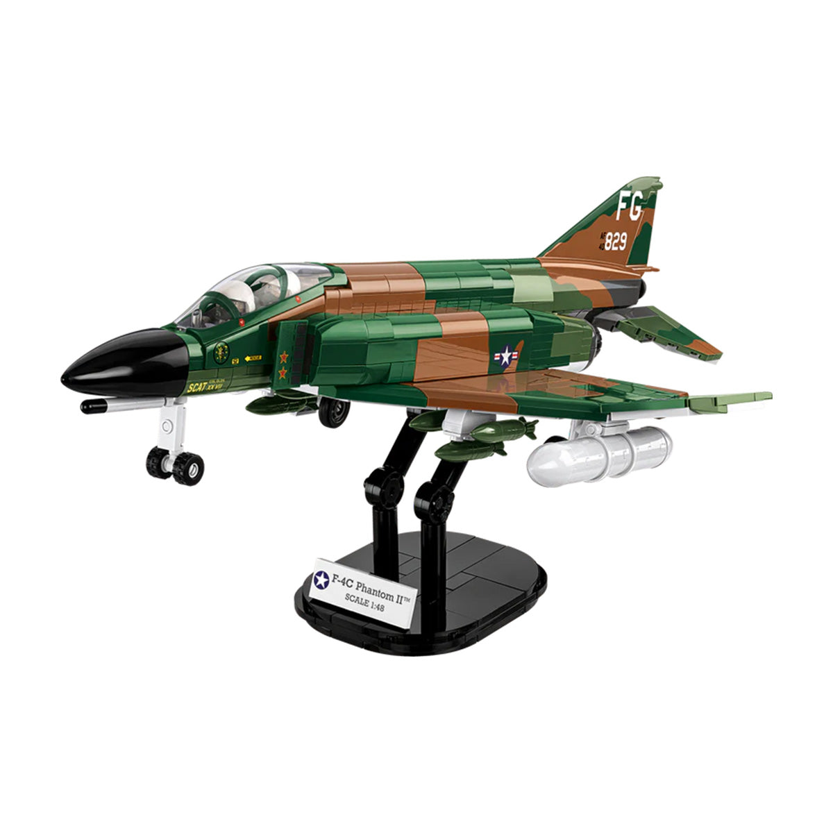 The COBI F-4C Phantom II by BOEING is a detailed fighter jet model in green and brown camouflage, displayed on a black stand. Features intricate landing gear, cockpit, and missile mounts—perfect for aviation fans and COBI set collectors.