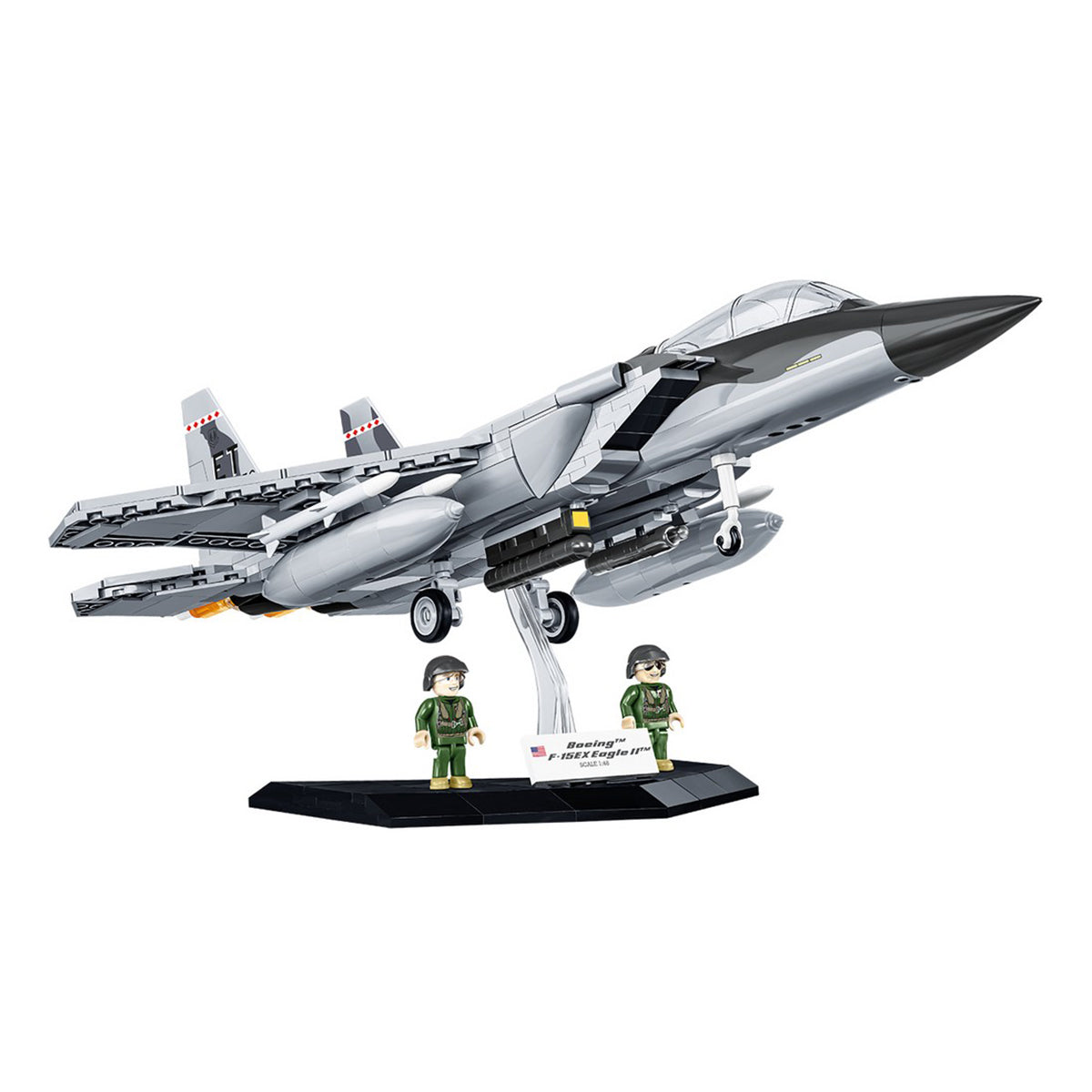 The COBI Boeing F-15EX Eagle II by BOEING features swept-back wings, a display stand, and two pilot figurines in green uniforms—an impressive choice for aviation scale model collectors. Set against a white background.