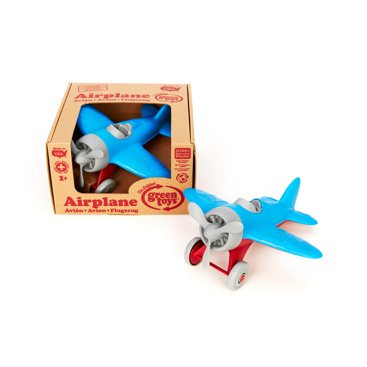The Green Toys Airplane - Blue, made from recycled materials, features vibrant red wheels. Its displayed with its cardboard packaging, labeled with the brand GREEN TOYS and suitable for ages 1 and up.