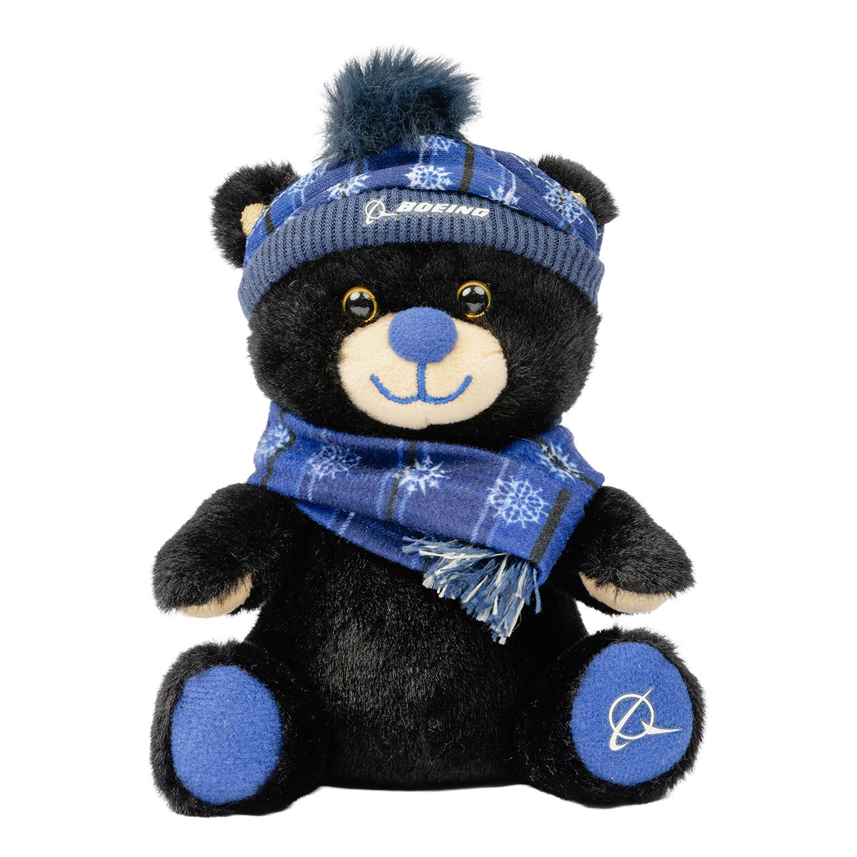Boeing 2026 Jet Snowflake 10″ Plush Bear, a black plush aviation teddy bear wearing a blue snowflake-patterned scarf and a matching knit hat with a pom-pom.