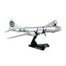 The DARON Boeing B-29 Superfortress Enola Gay Diecast Model is a silver, 1:200 scale replica with black propellers and features the marking 82 with star insignia. Mounted on a black stand labeled B-29, its tail displays a bold black R within a circle.