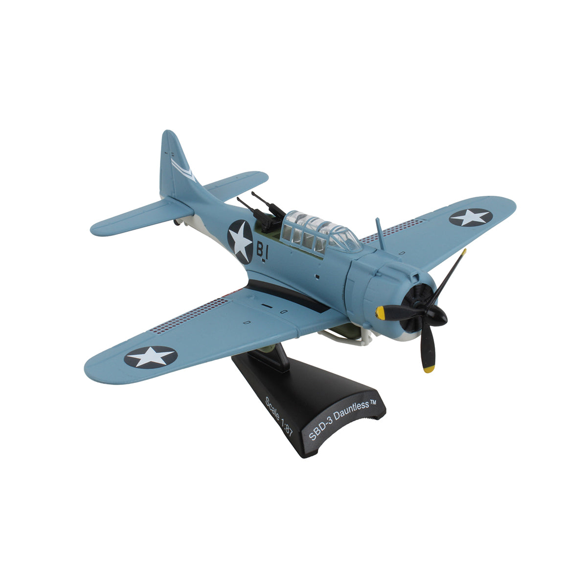 The DARON Boeing SBD-3 Dauntless Diecast Model is a 1:87 scale replica of the blue WWII dive bomber with white star insignias, displayed on a black stand labeled “SBD-3 Dauntless.”.