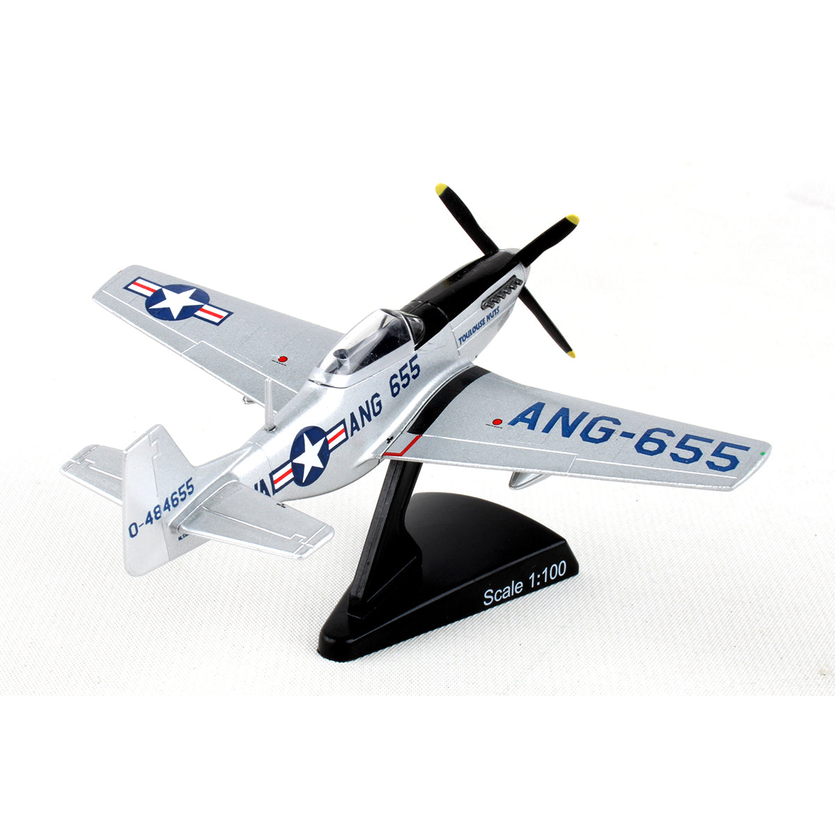 The DARON Boeing P-51D Mustang Toulouse Nuts Diecast Model features a silver finish, black and yellow propeller, blue ANG-655 markings, U.S. Air Force insignia, and sits on a Scale 1:100 display stand against a white background.