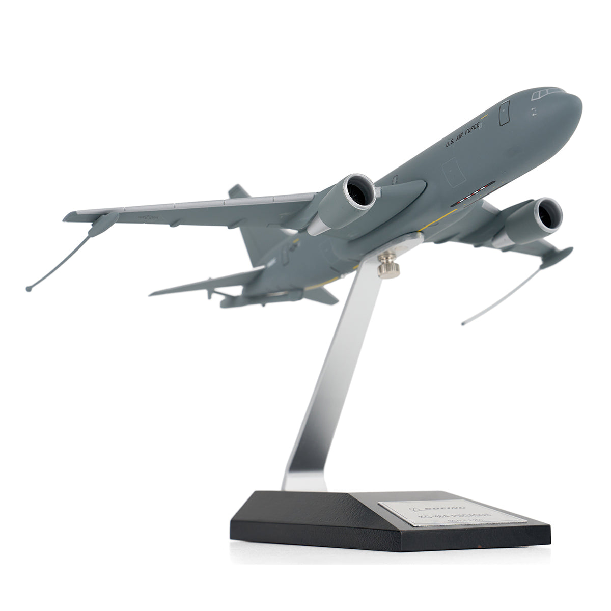 The DARON Boeing KC-46A Pegasus 1:200 Model features a gray finish and comes mounted on an angled stand with a black base and front plaque, making it ideal for collectors.