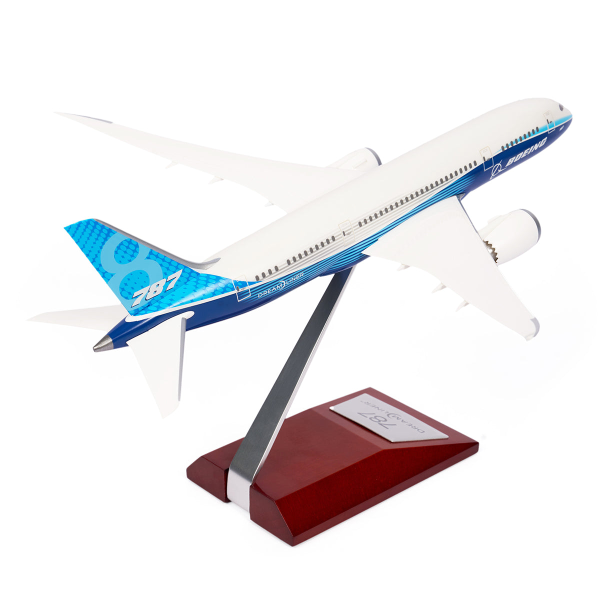 The Boeing Store offers a Boeing Unified 787-8 Dreamliner 1:200 Model, featuring a blue and white design. The airplane is mounted on a wooden base at an angle, highlighting its wings and engines—a tribute to modern aviation.