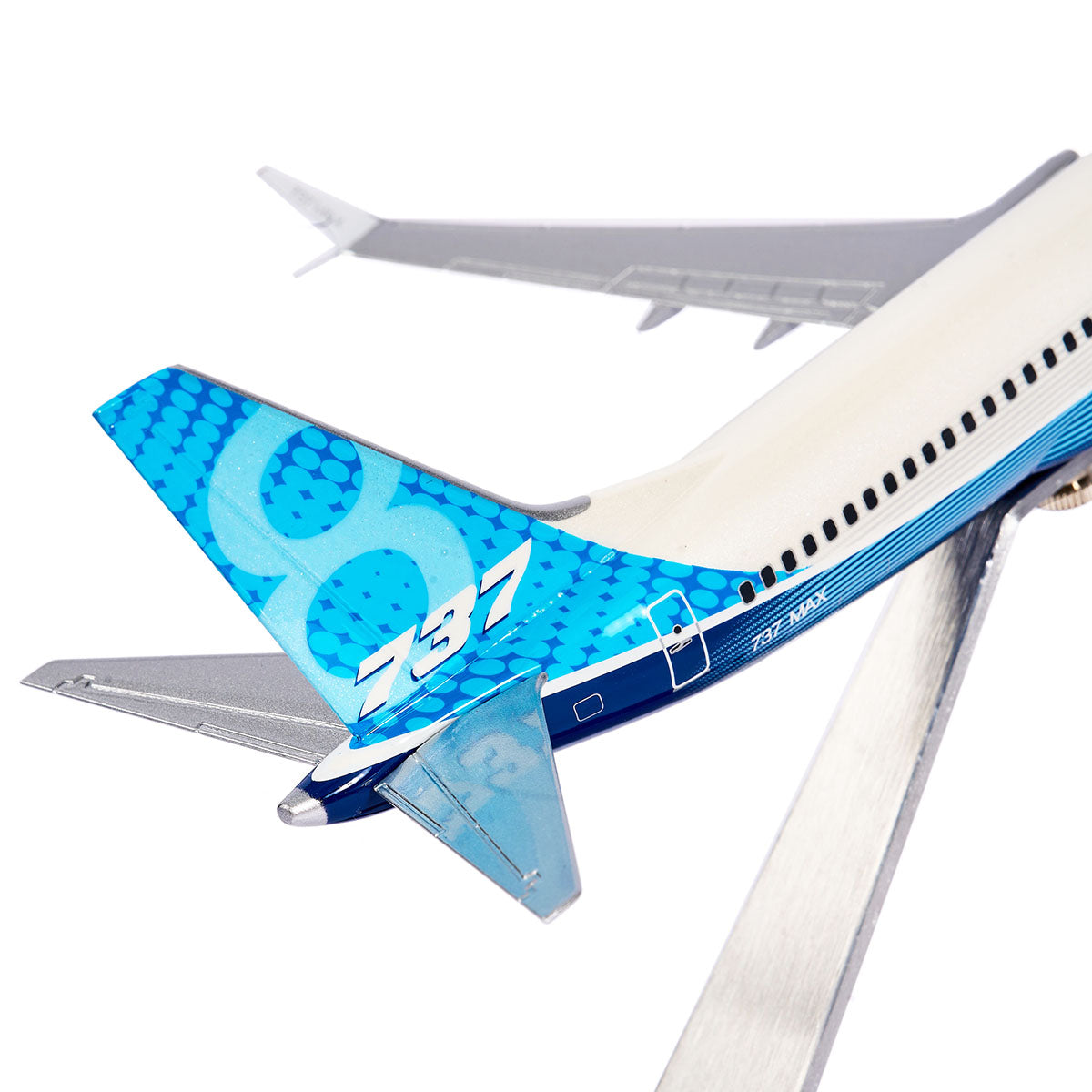 The Pacific Miniatures Boeing Unified 737 MAX 8 1:144 Model features a detailed blue and white tail with 737 MAX 8 in white. Its made from precision injection-molded plastic, sits on a metal stand against a plain white background, showcasing fuel efficiency.