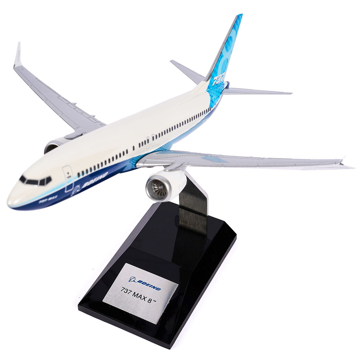 The Boeing Unified 737 MAX 8 1:144 Model from Pacific Miniatures, made with precision injection-molded plastic, showcases a blue and white design and sits on a sleek black stand featuring a metallic plaque labeled 737 MAX 8 with the logo against a plain white background.