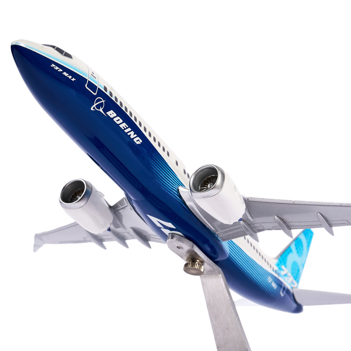 The Boeing Unified 737 MAX 8 by Pacific Miniatures is a detailed 1:144 model with a blue and white fuselage, crafted from precision injection-molded plastic. It features Boeing 777X on the side and is mounted on a stand, highlighting its engines and intricate design from below.