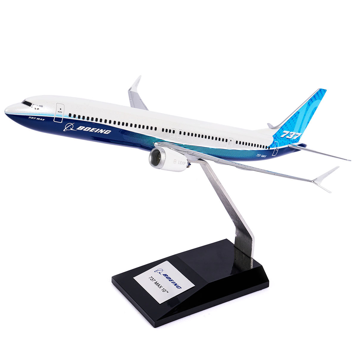 The Boeing Stores Boeing Unified 737 MAX 10 1:144 Model is a white and blue model with Advanced Technology winglets, mounted on a sleek black stand. It features the Boeing logo and Sky design elements against a plain white background.