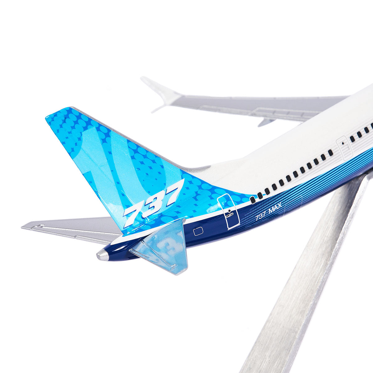 This sleek Boeing Unified 737 MAX 10 model from The Boeing Store, painted in blue and white with 737 on the fin, stands on a metal base. It displays 737 MAX near the rear fuselage and features advanced technology winglets for enhanced performance.