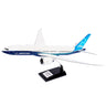 The Boeing Stores Boeing Unified 777-8 1:144 Model features a sleek white and blue design with a distinctive tail fin. Mounted on a black stand with a silver plaque, this model captures the elegance and innovation of modern twin-engine jets.