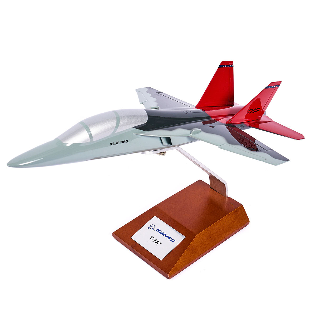 The Boeing Store’s Boeing T-7A Red Hawk 1:48 Model features a gray and red paint scheme, silk screen printed details inspired by the Tuskegee Airmen, and is mounted on a wooden base with a Boeing T-7A plaque.