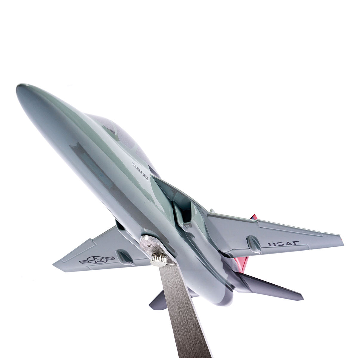 The Boeing Store’s Boeing T-7A Red Hawk 1:48 Model is displayed on a metal stand, shot from below against a white background, showcasing its wings, tail, USAF insignia, and silk screen-printed details.