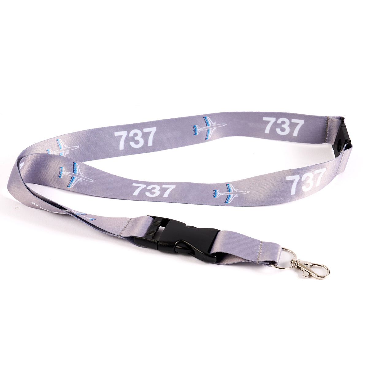 The Boeing Stores Boeing 737 Motion Lanyard is gray with a repeated sublimation print of airplane graphics. It features a black plastic buckle and a metal clip, ideal for fans of aviation-themed accessories.