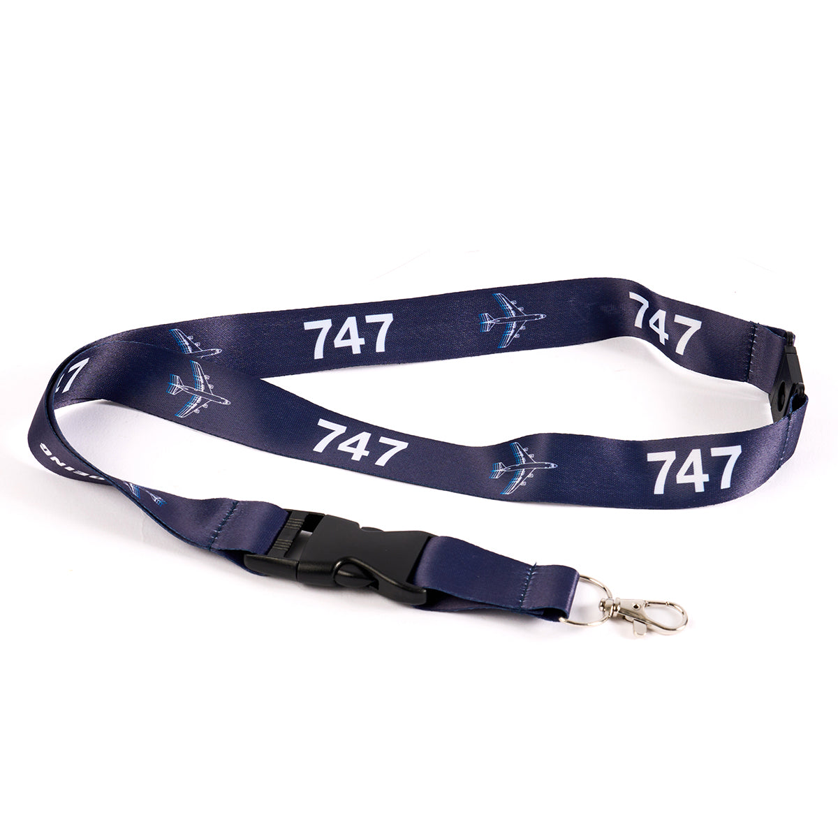 The Boeing Stores navy blue Boeing 747 Motion Lanyard features white 747 sublimation print and airplane graphics, with a black plastic buckle and silver metal clip. This aviation-themed item is displayed flat on a white background.