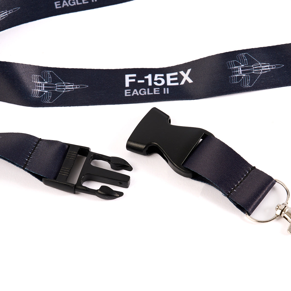 The Boeing Stores Boeing F-15EX Eagle Motion Lanyard showcases navy blue aviation-themed designs of the F-15EX Eagle II and jets. It includes a black plastic buckle and metal clip end.