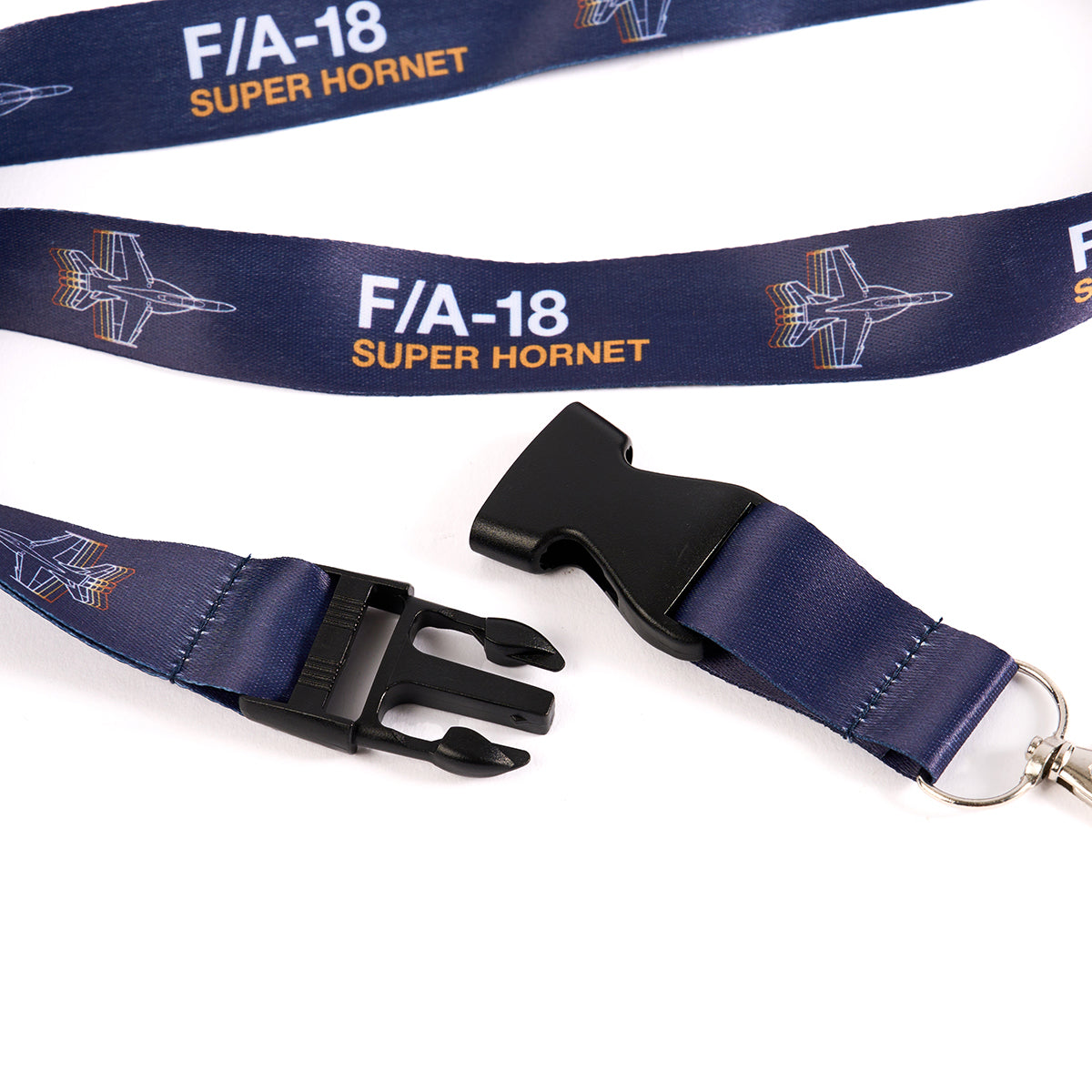 Close-up of The Boeing Stores dark blue F/A-18 Super Hornet Motion Lanyard featuring aircraft illustrations, a black plastic buckle, and metal clip. Aviation-inspired design.