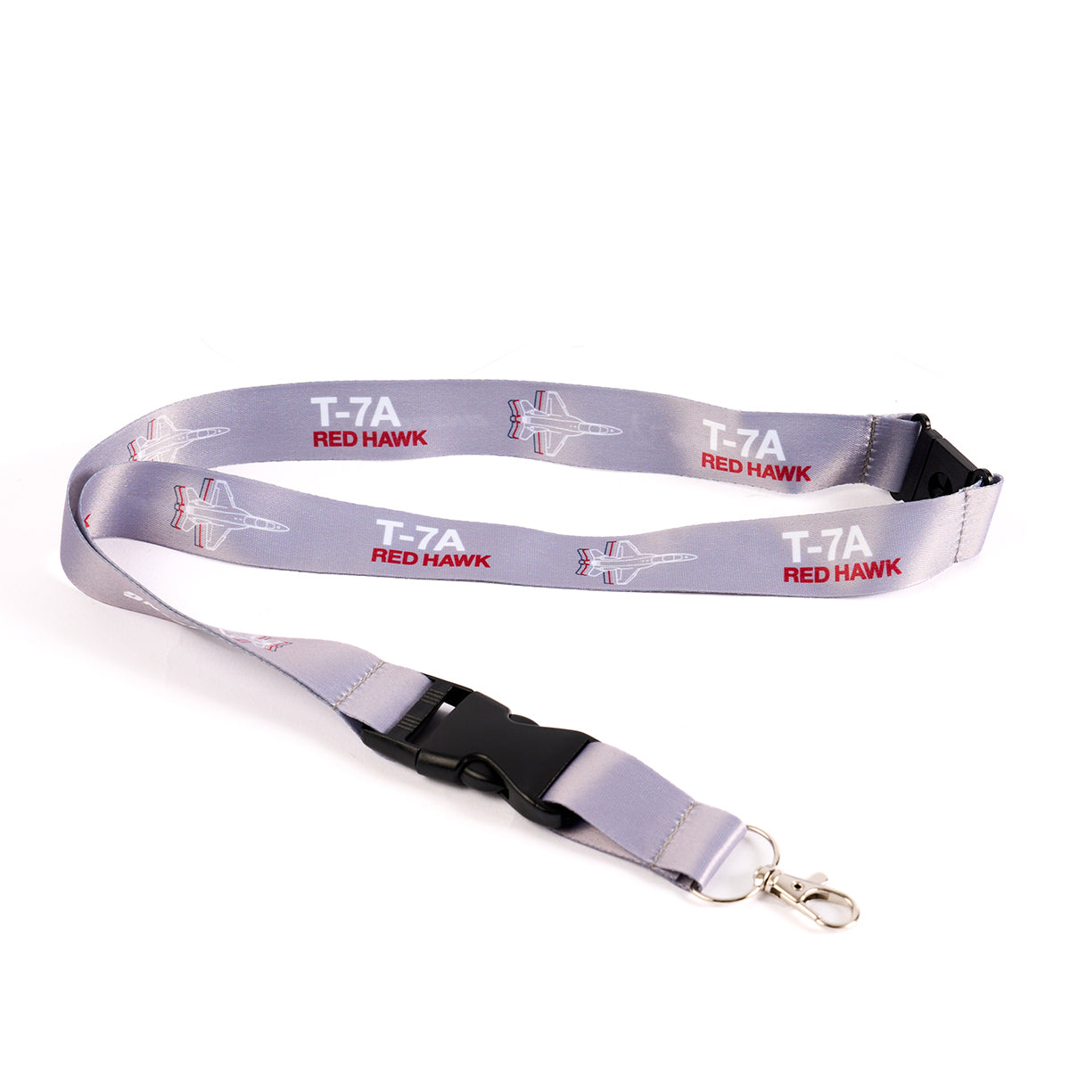 The Boeing Stores Boeing T-7A Red Hawk Motion Lanyard features aviation-inspired gray design with T-7A Red Hawk text and jet illustrations. It includes a metal swivel hook and black plastic buckle.