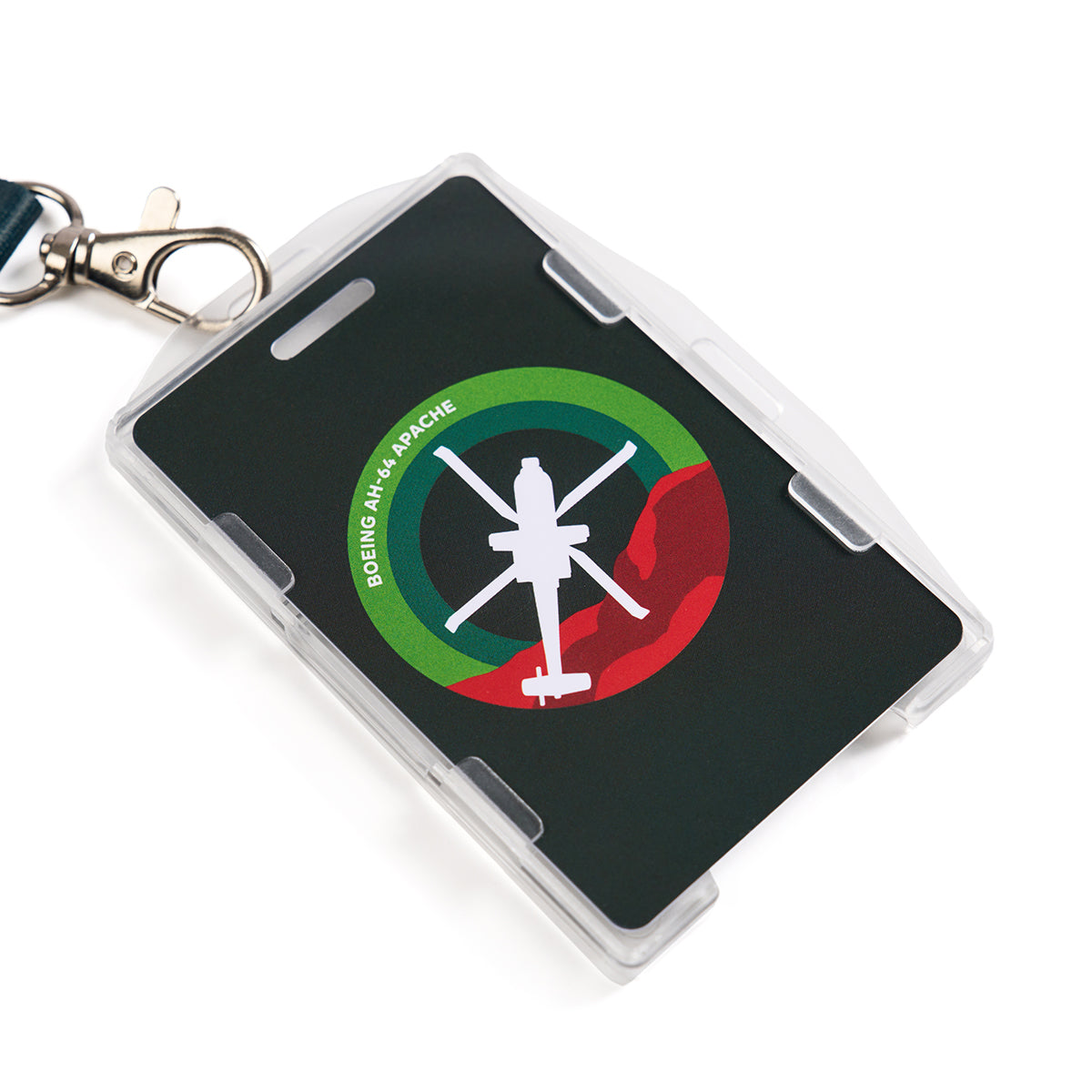 The Boeing AH-64 Apache Skyward Lanyard features a metal clip holding an ID badge with the white silhouette of an AH-64 Apache over a green and red circular background. The text reads Boeing AH-64 Apache, and the lanyard is designed in sleek black and white.
