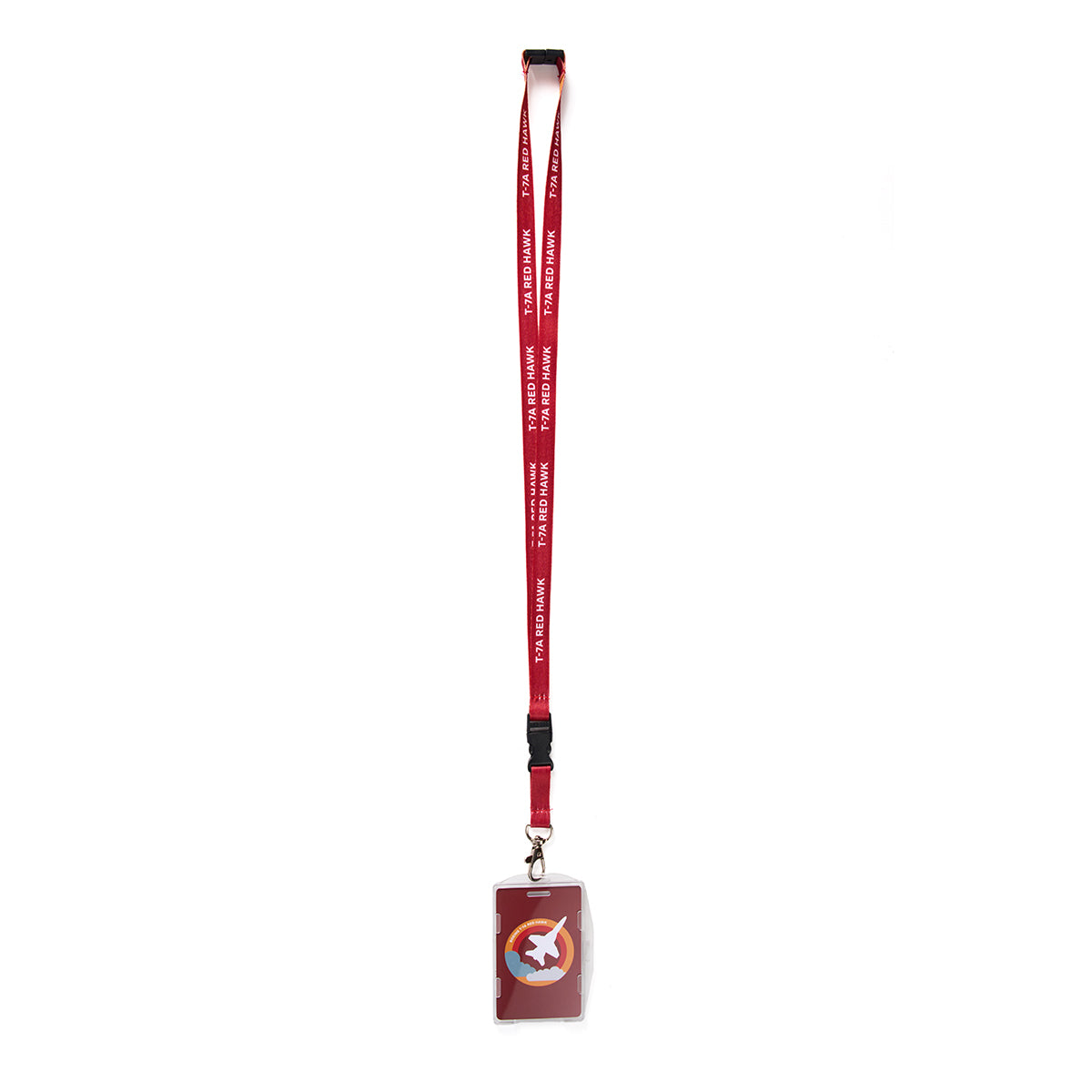 The Boeing T-7A Red Hawk Skyward Lanyard by Boeing is red with ANOTHER PLANET printed in white. It features sublimation print, a black clip, and a transparent ID card holder containing a card with a multicolored circular design featuring a star and rocket, set against a white background.
