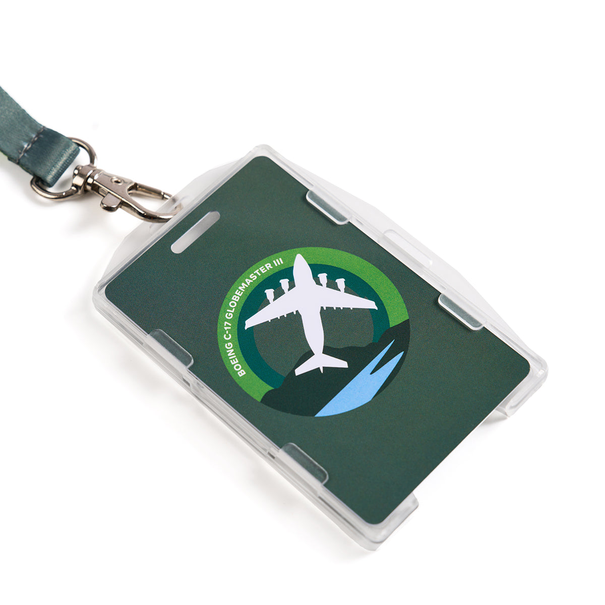 The Boeing C-17 Globemaster Skyward Lanyard holds a name tag card with sublimation print, illustrating a plane and the text Boeing C-17 Globemaster III. The design includes a silhouette on a circular blue and green background.