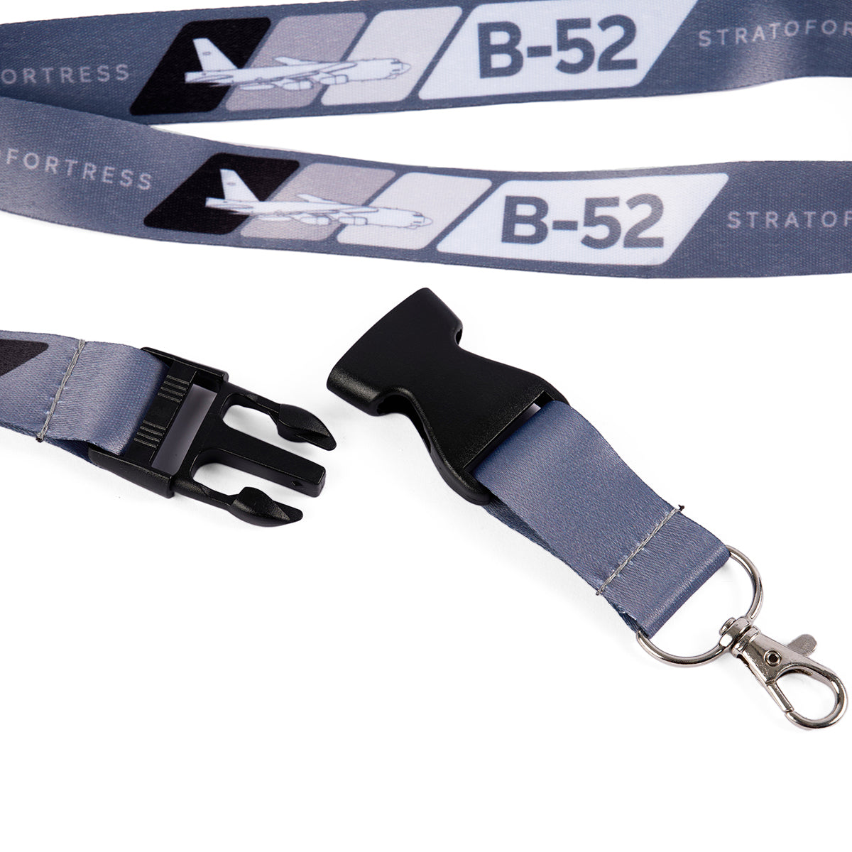 The Boeing B-52 Velocity Lanyard by Boeing, in blue, features sublimation prints of the B-52 Stratofortress and airplane illustrations. It includes a black plastic buckle and metal clip, making it ideal for aviation enthusiasts.
