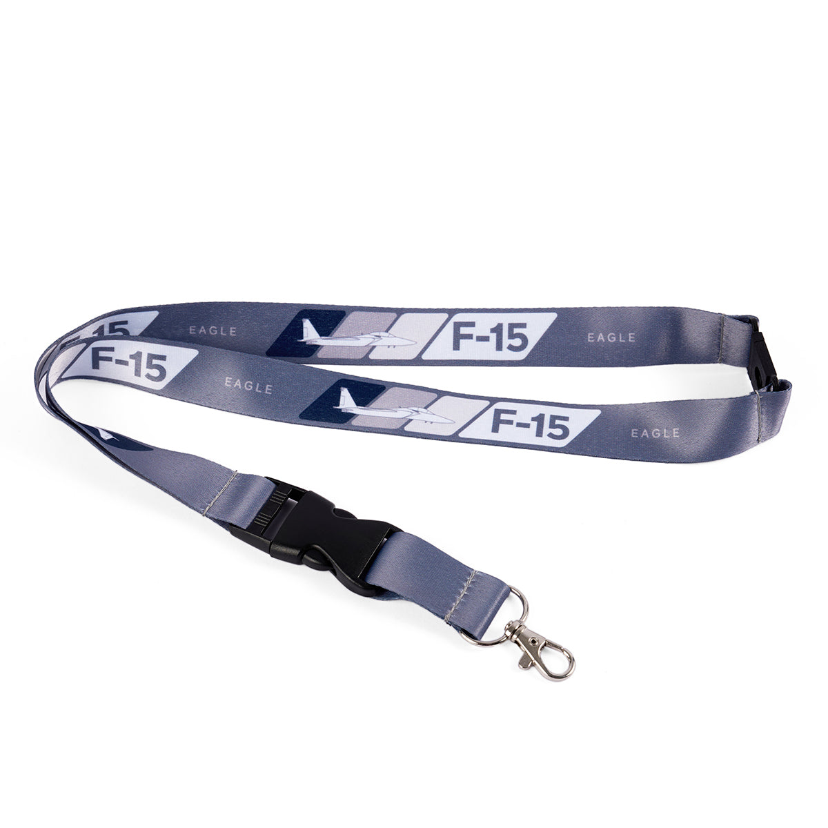 The Boeing F-15 Eagle Velocity Lanyard, by Boeing, is a gray lanyard with sublimation print featuring Boeing F-15 text and an aircraft design. It has a black plastic buckle and a metal swivel hook at the end.