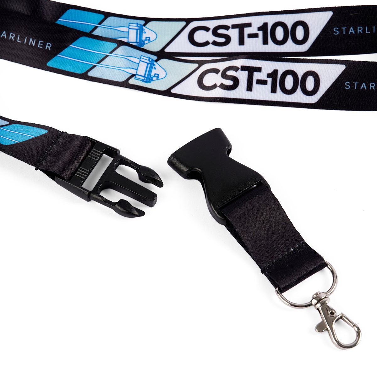 The Boeing CST-100 Starliner Velocity Lanyard displays blue and white sublimation prints of the spacecraft on a black background. It includes a metal swivel hook, safety breakaway buckle, and blue stylized spacecraft images.