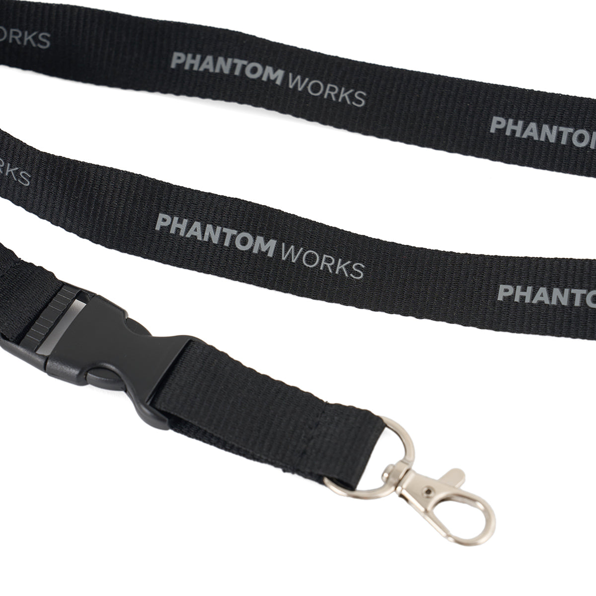 The Boeing Phantom Works 2025 Lanyard by BOEING features a metal clip, plastic buckle, and "PHANTOM WORKS" repeatedly printed in white—perfect for aviation enthusiasts.