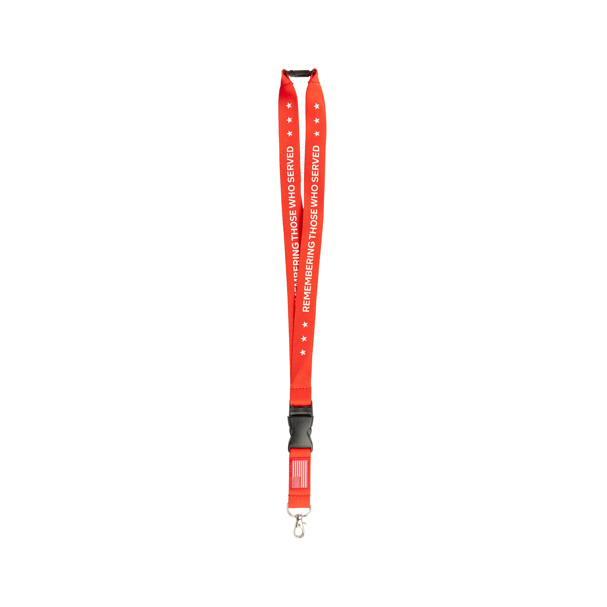 Introducing the Boeing Remembering Those Who Served Lanyard by BOEING. This vibrant red commemorative lanyard features white stars and the phrase "REMEMBERING THOSE WHO SERVED." Designed with a black plastic buckle, safety breakaway for added security, metal clasp, and a small American flag near the bottom.