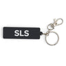 The BOEING Space Launch System Series Keychain features a black rectangular PVC design with white SLS lettering, a silver keyring, and metal clasp—an ideal accessory for aviation enthusiasts.