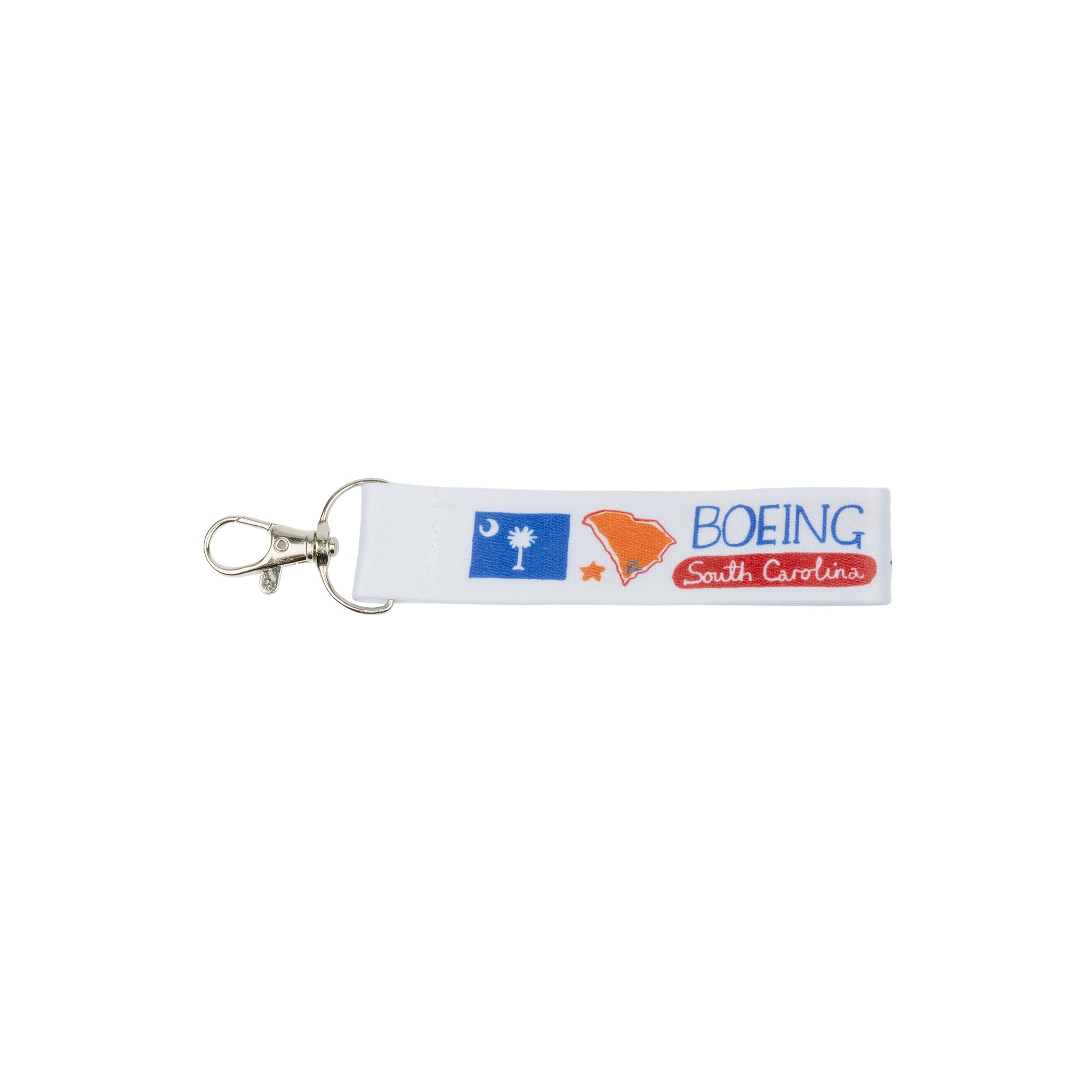 Introducing the Boeing South Carolina Strap Keychain by Boeing—a white fabric keychain adorned with the South Carolina flag, a state outline, and “BOEING South Carolina” in bold blue and red lettering. Attached to a silver clasp, this distinctive accessory pays tribute to South Carolina’s role in aerospace manufacturing.