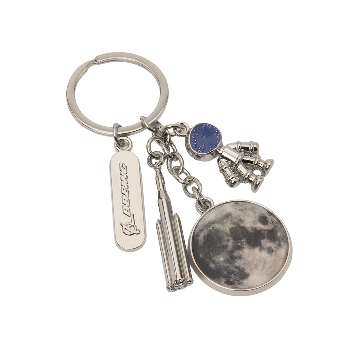 The BOEING SLS Charm Keychain is a metal keychain featuring multiple charms: a rectangular charm labeled “Boeing,” a rocket representing space exploration, an astronaut, a blue planet, and a round charm displaying a photo of the moon.