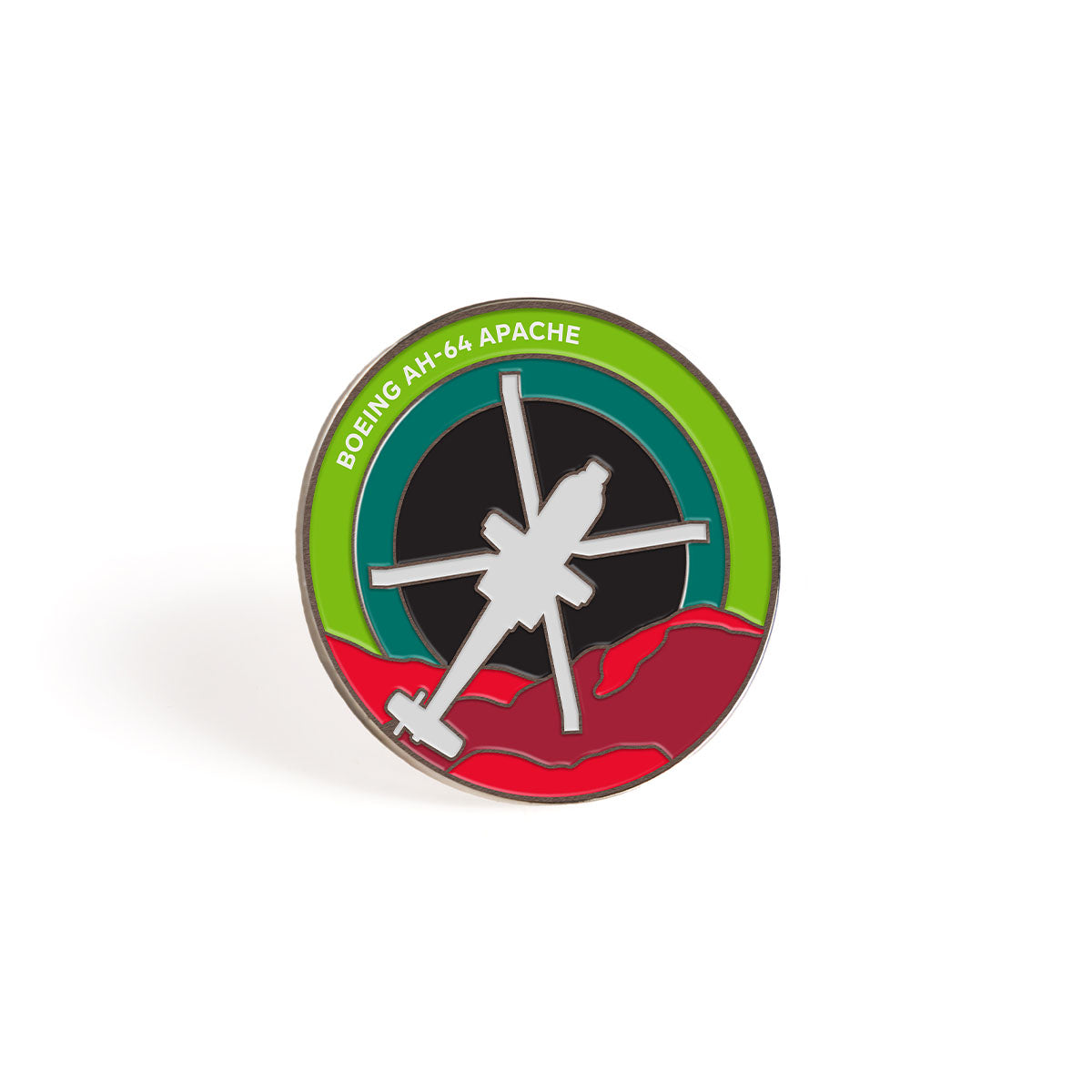 The Boeing AH-64 Apache Skyward Lapel Pin by Boeing features a white silhouette of an Apache helicopter against bold red and black, encircled by a green ring, with Boeing AH-64 Apache text—ideal for aviation enthusiasts.